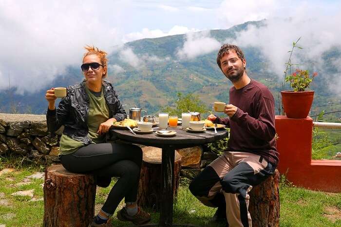 Tourist couple on a Nepal honeymoon eating breakfast in at Nagarkot