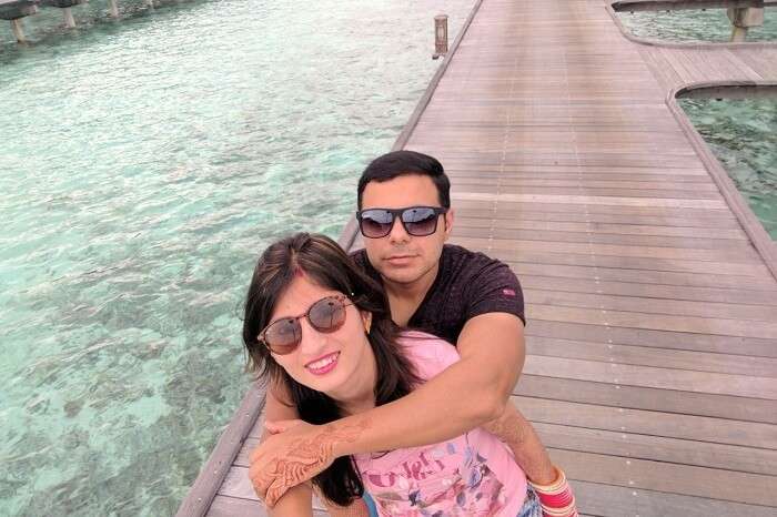 Couple taking selfie near water villas