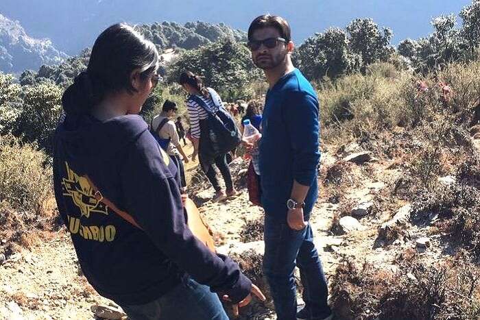 A man gets his picture clicked during downhill trek