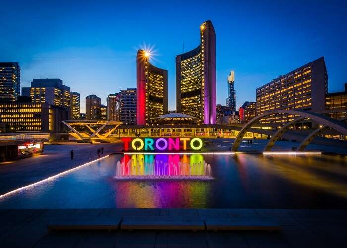 View of Nathan Phillips Square and Toronto Sign in downtown at night, in Toronto