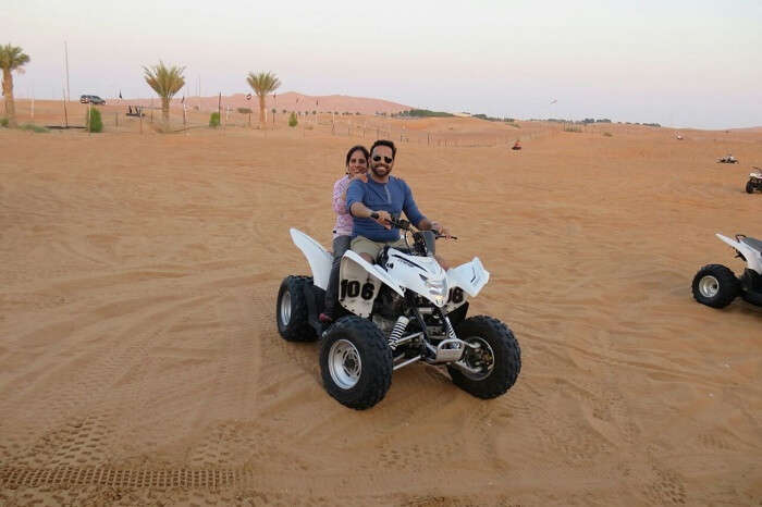 Couple enjoying desert safari on quadbike in Dubai