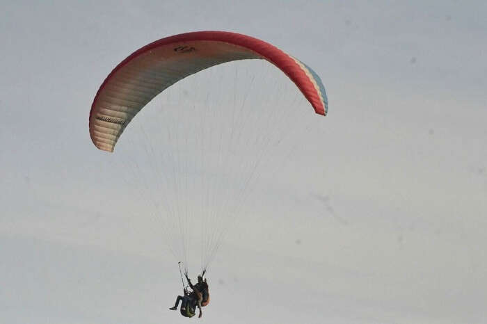 Man enjoying paragliding with wingman