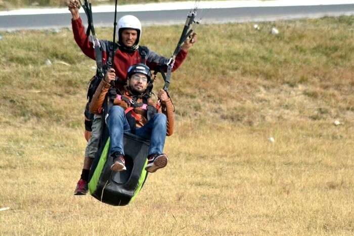 A man landing after his paragliding adventure