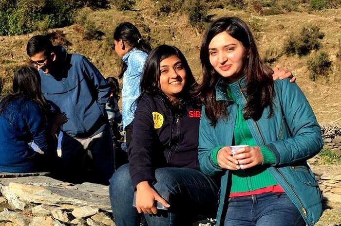 Two girls getting their picture clicked on a trip