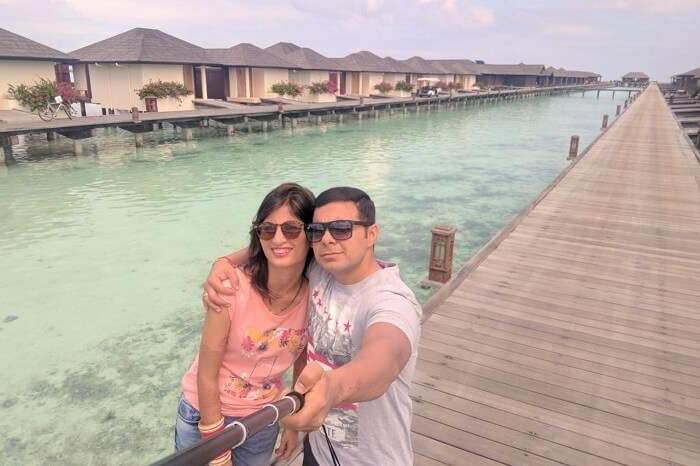 couple clicking selfie near water villa