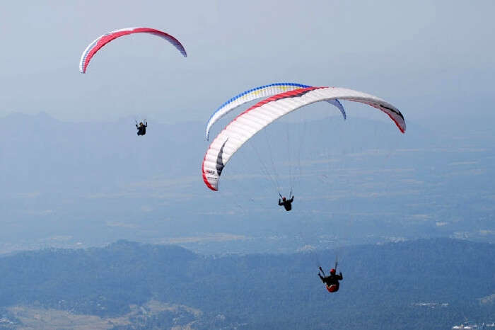 Paragliders enjoying paragliding in Khajjiar