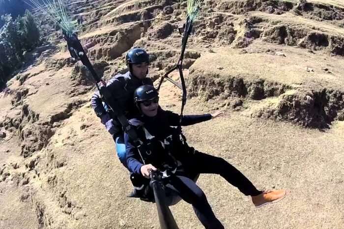 Thrilled paraglider immediately after jumping in Khajjiar