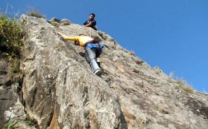 A person trying rock climbing in Mukteshwar 