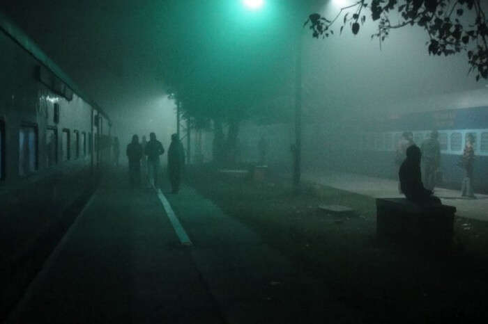 Train at a station on a foggy night