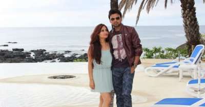 Amit standing on a sea beach with his wife during a honeymoon trip to Mauritius