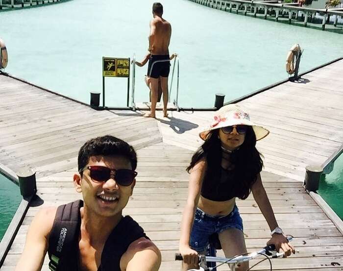 Nisarg and his wife cycling at their resort