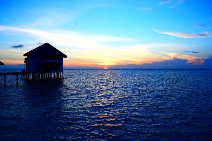 kishor & wife enjoying sunset from their water villa in maldives