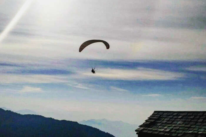 someone engaging in paragliding in the distance