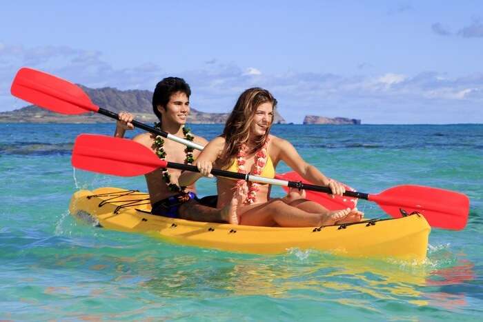 A couple kayaking in the sea at Kauai island on their Hawaii honeymoon