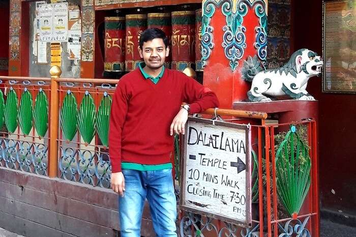 A traveler posing outside Dalai Lama temple in Mcleodganj