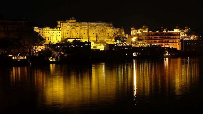 reflection of a palace on lake water at night