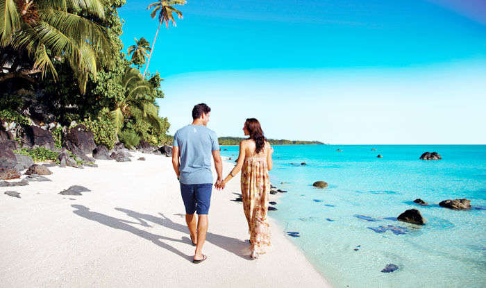Couple walking on the beach in Cooks Islands