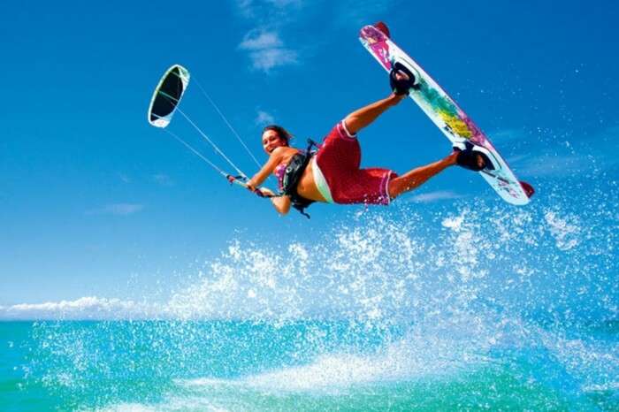 A honeymooner trying surf boarding on a beach in Sri Lanka