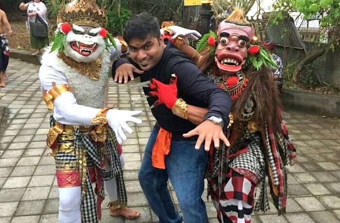 Man with masked dancers Bali