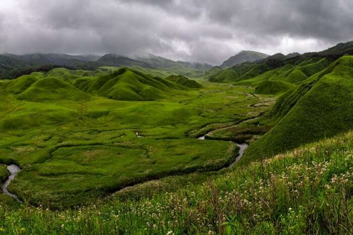Dzukou Valley near Manipur & Nagaland border with clouds hovering over it