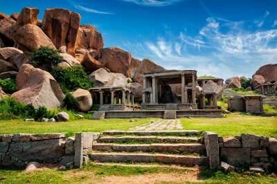 Ancient ruins in Hampi surrounded by large rocks that had kept the ancient Indian city hidden for years