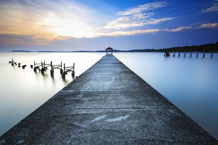 Stunning vibrant sunset at jetty of fisherman beach in Port Dickson