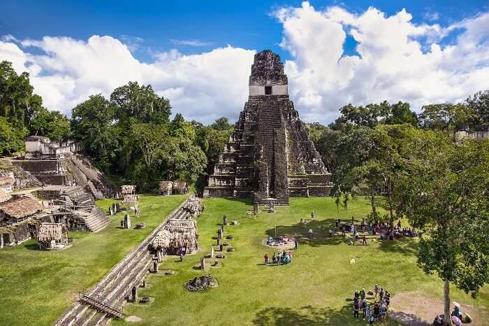 Tourists at the Gran Plaza at the archaeological site Tikal in Guatemala