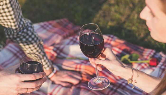 couples sitting together drinking wine is one of the romantic things to do on honeymoon