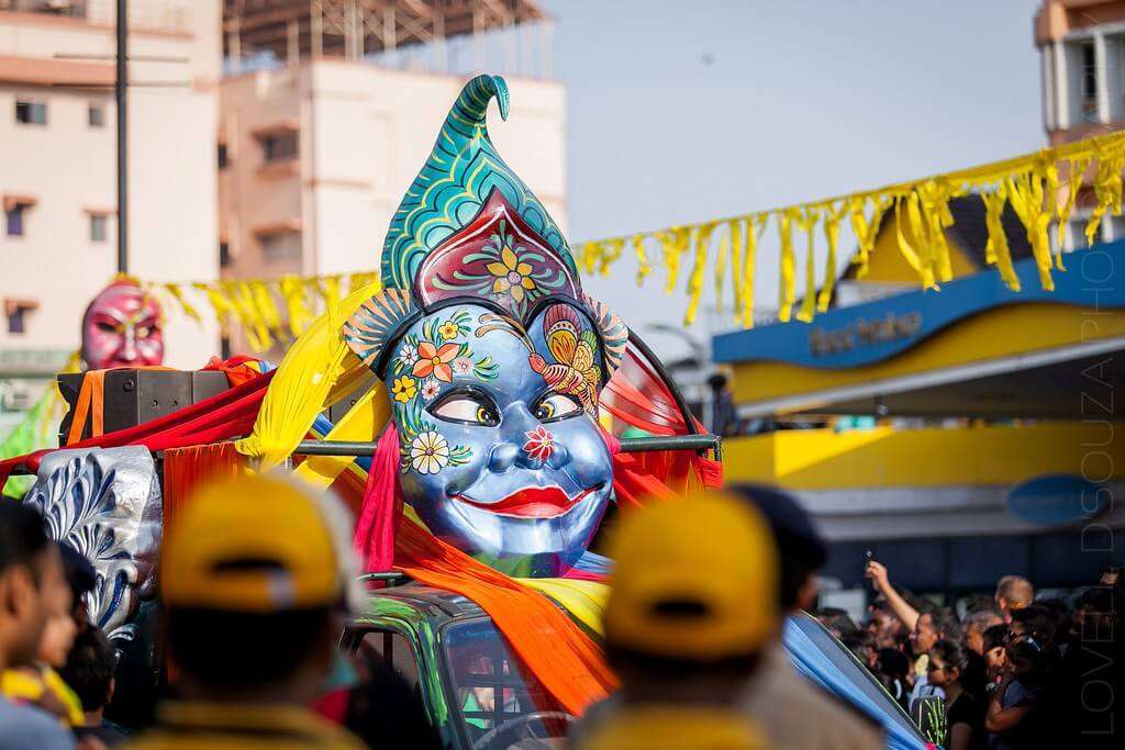a big mask during float parade in Goa carnival