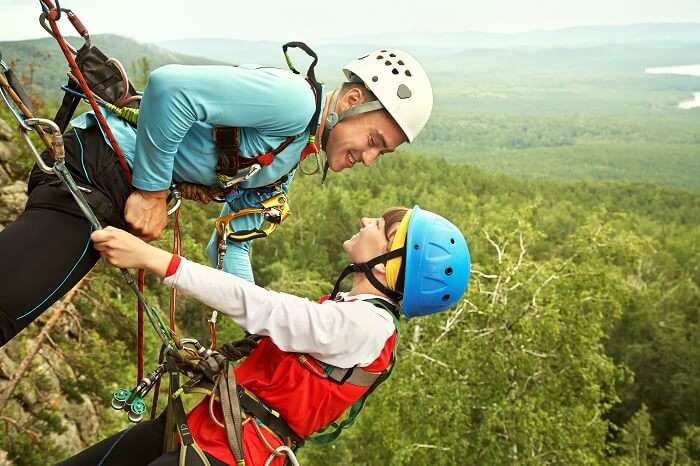 Romantic couple rock climbing in Utah