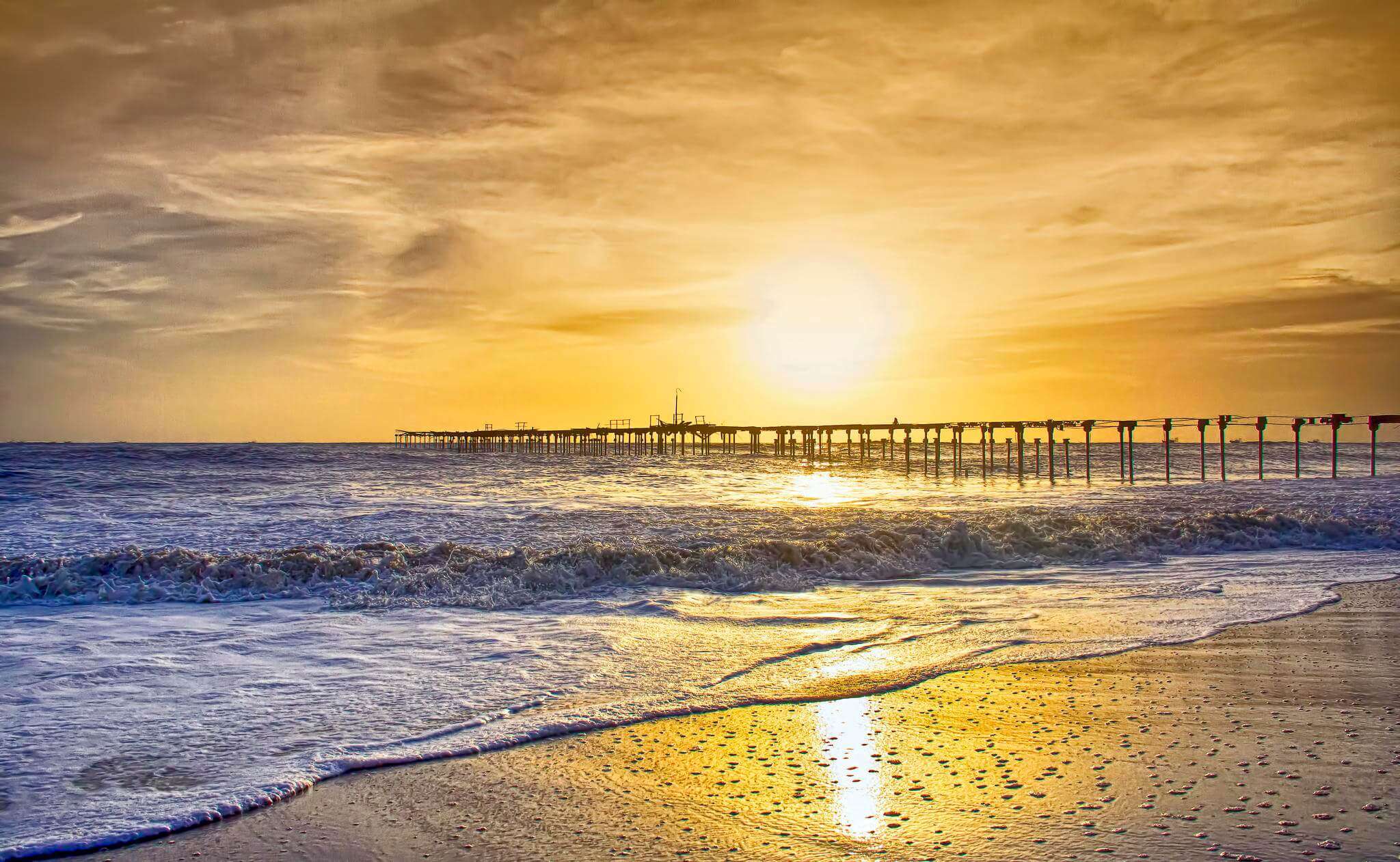 sunset behind a pier at Alleppey beach