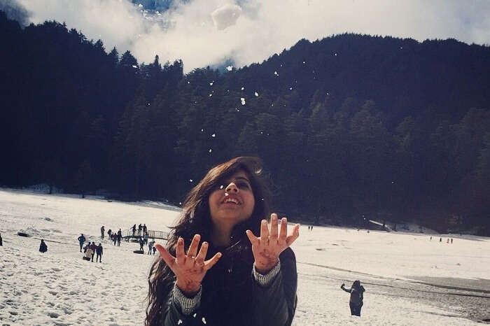 Girl playing with snow in Dalhousie