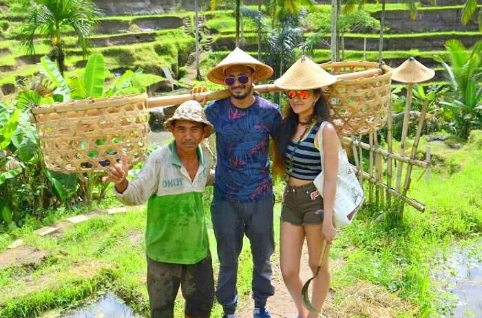 A couple with locals on their eco-tourism honeymoon in Ubud