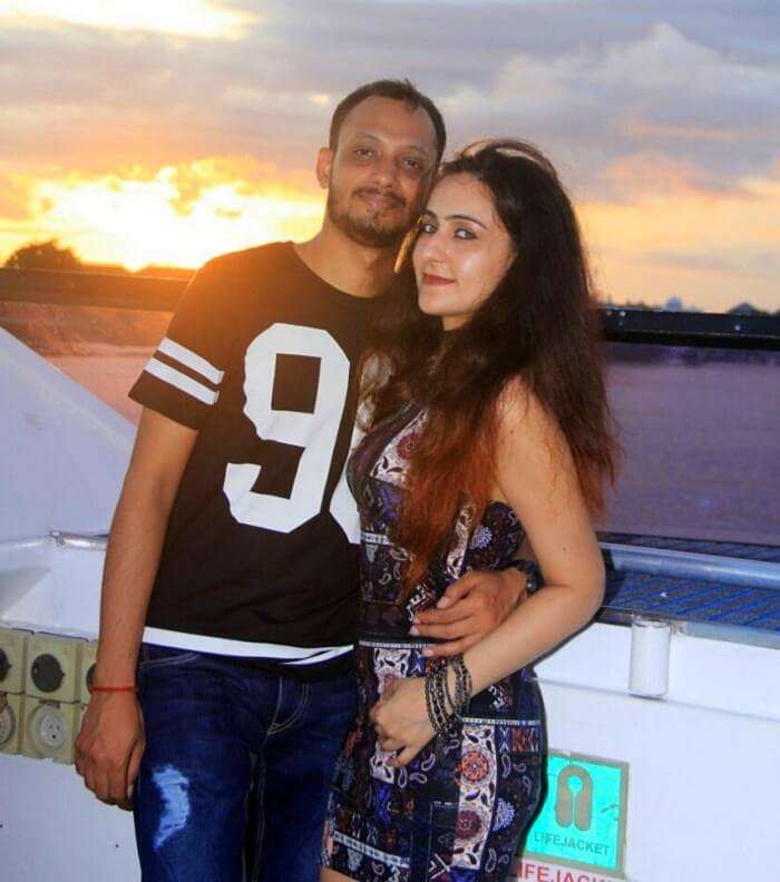 Sanchit and his wife in the background of sunset on the bali high sunset cruise