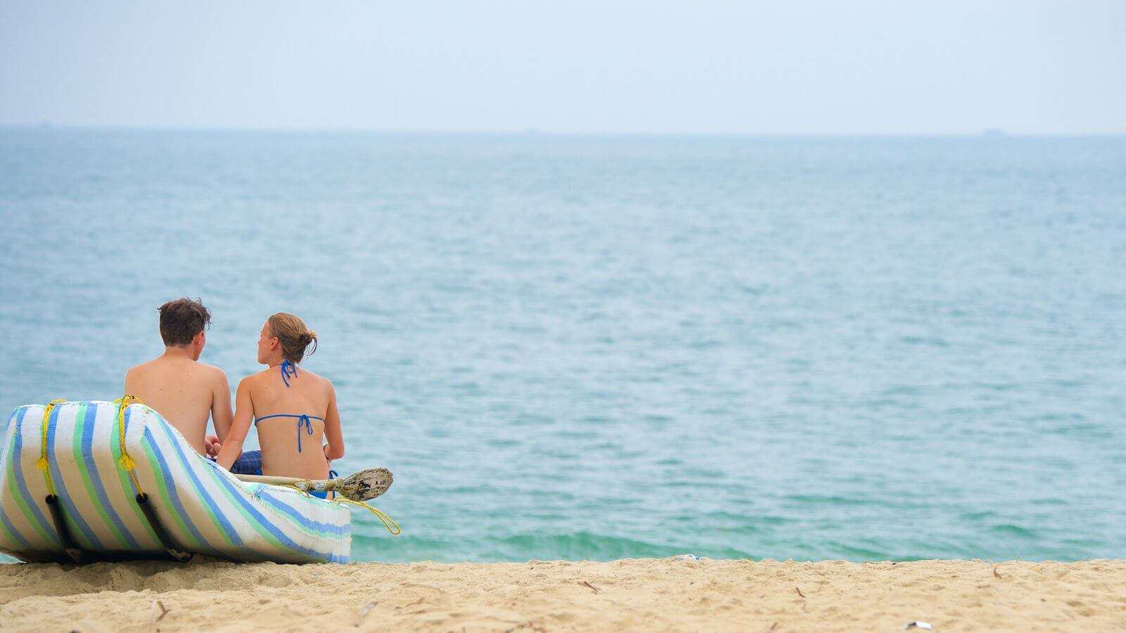 a couple relaxing at Marari beach in Alleppey