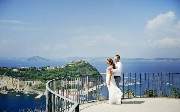 A couple enjoying the views of Naples - one of the best honeymoon destinations in Italy 