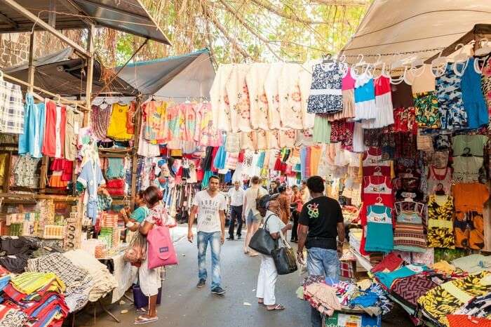 People buying clothes from market street in Port Louis in Mauritius