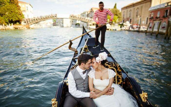  A couple in a venetian Gondola in Italy