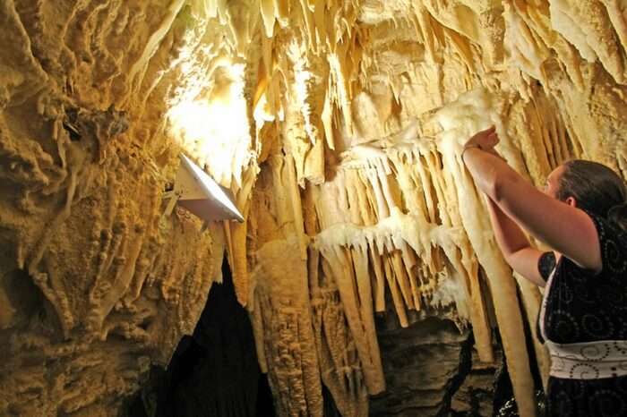 Tourists watching the interiors of Aranui Caves in Waitomo