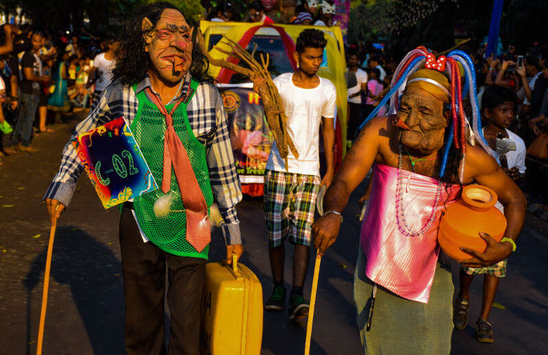 two men wearing shaggy skin mask in Goa carnival