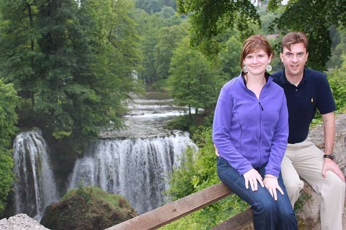 Mike & Luci posing for a photograph by a waterfall in Slovenia