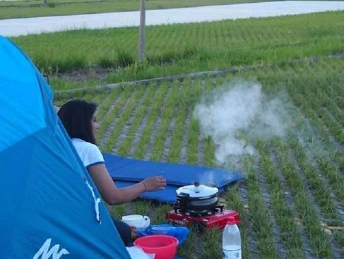 Punita cooking food on the go during their road trip to Paris