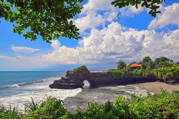 Bow down at Tanah Lot temple in Bali, Indonesia
