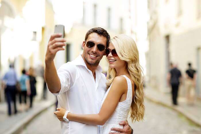 Romantic honeymoon couple clicking selfie