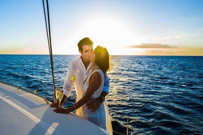 A couple kissing onboard catamaran