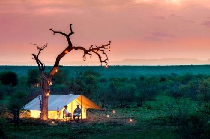 Couple sitting outside a tented lodge in South Africa