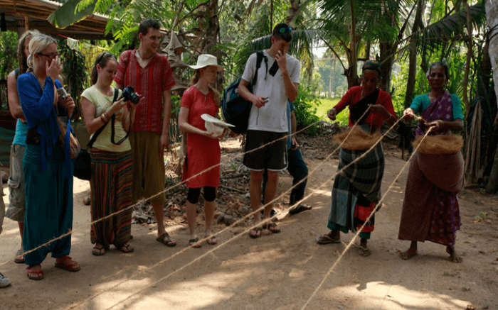 Tourists learning the village culture during an ecotour in a village in Kerala