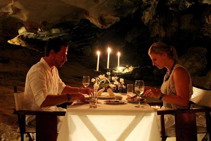 A couple enjoys a romantic dinner in the caves of Halong Bay
