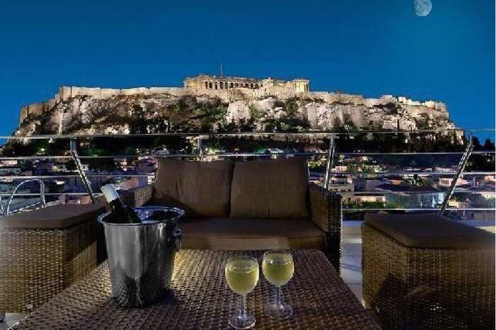 A beautiful dining setup overlooking Plaka in Greece at night