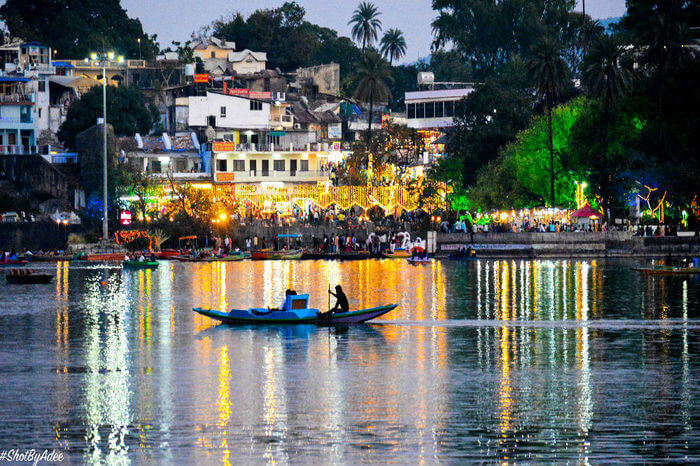 reflection of city lights on the water of lake